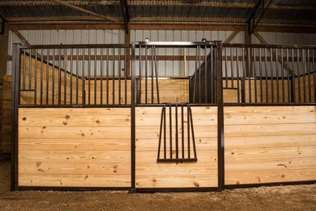 Tarter Excel horse stall front with wood infill in a barn; manufacturer example